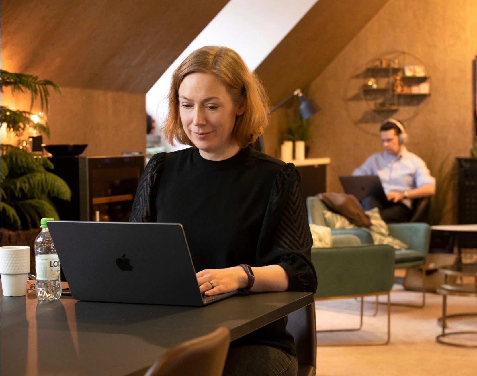 Helena arbetar vid sin laptop på Alphadevs kontor.